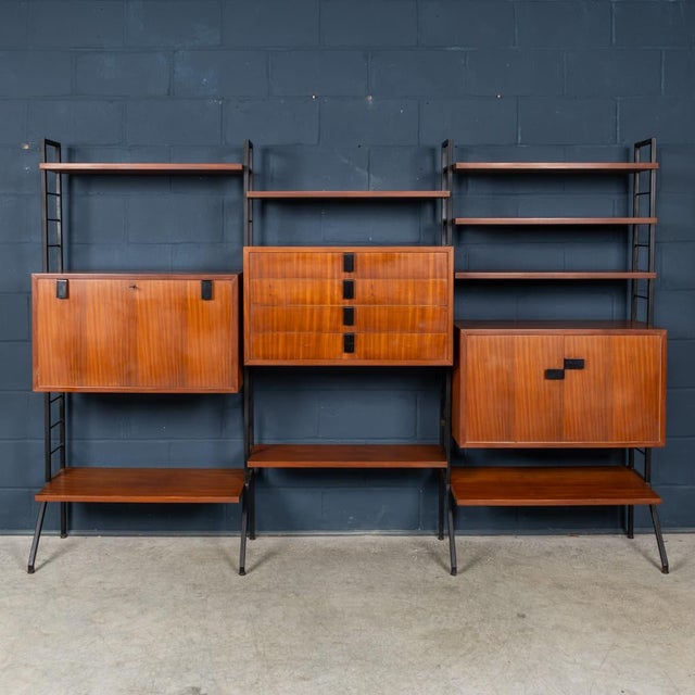 An impressive Italian modular wall storage and shelving system dating from the 1960s, combining warm teak cabinetry and...