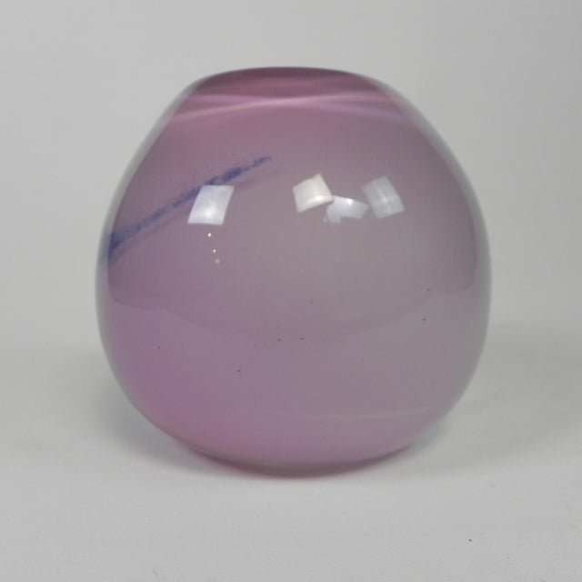 This spherical vase is crafted from thick-walled pink glass with abstract purple details. Height: 16 cm. Diameter: 18 cm....