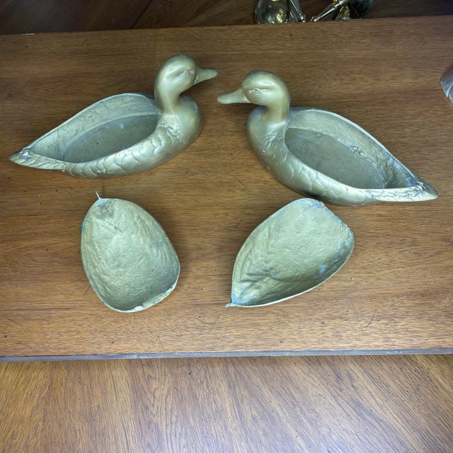 A matching pair of brass ducks or mallards with removable lids. These could be used as an ashtray, for storage of smaller...