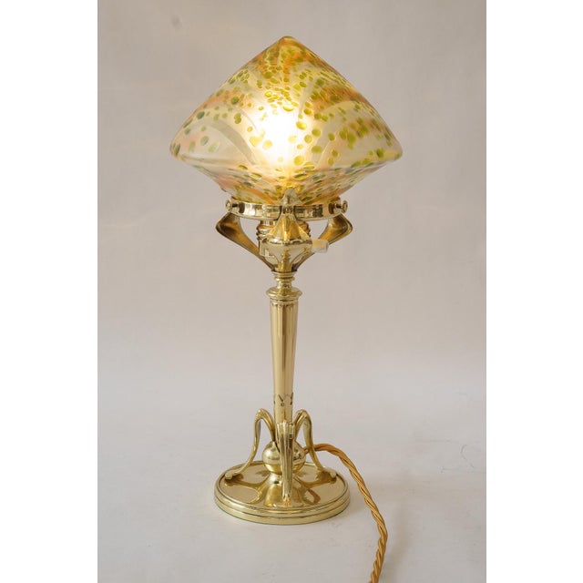 Floral Jugendstil table lamp with loetz glass shade around 1908 Brass polished and stove enameled Original loetz glass...