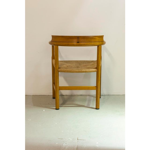 This set of four chairs was designed by Hans J. Wegner in the 1960s and produced in Denmark. It features a wooden frame...