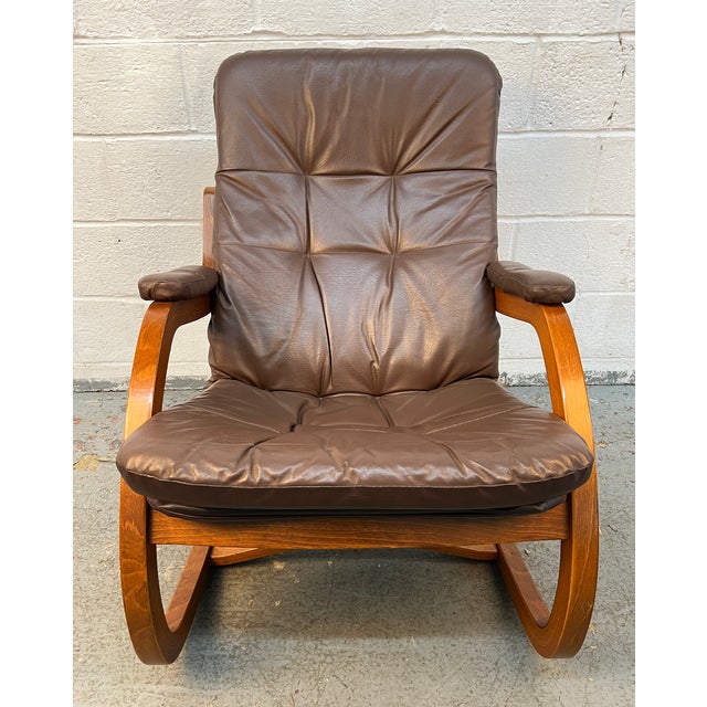 The chair features a beautifully sculpted, bentwood frame made from premium laminated wood, showcasing a rich, warm grain...