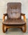 The chair features a beautifully sculpted, bentwood frame made from premium laminated wood, showcasing a rich, warm grain...