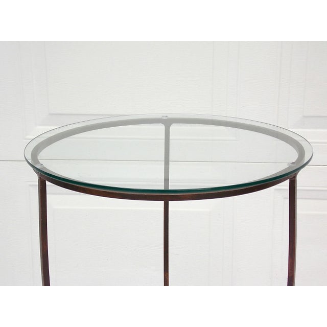 Metal and glass accent table with 3 curved feet and clear glass top. Can be a drinks, side table or plant stand. Base...