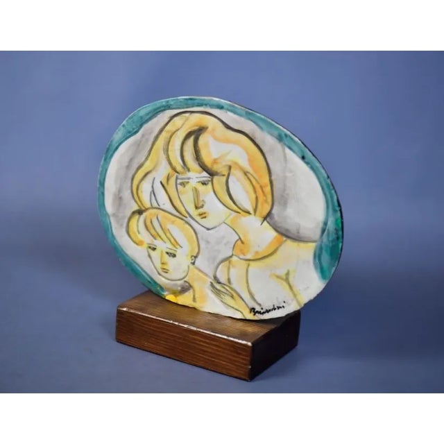 Fabulous tabletop work, original picture/painting by the famous Remo Brindisi. Glazed ceramic structure and wooden base...