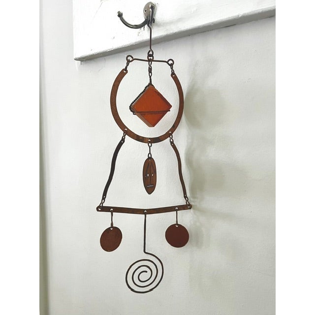 The image shows a pair of mid-century modern hanging metal and glass sculptures, which appear to be attributed to the...