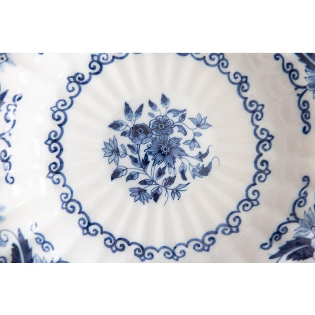 A gorgeous antique Dutch Delft faience floral scalloped wall charger plate by Royal Tichelaar Makkum, circa 1920. Maker's...