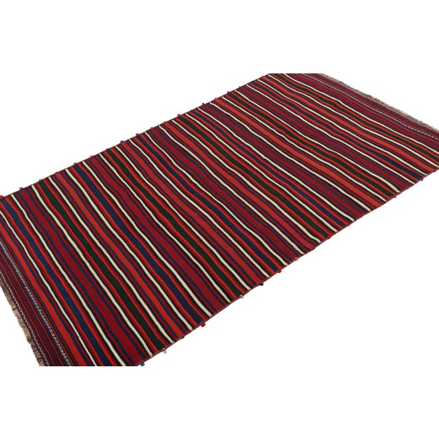 This vintage 6x10 Persian kilim is a mid-century tribal runner, handwoven in wool circa 1950-1960. On the Design: Its...