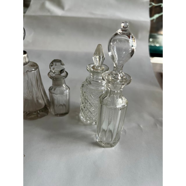 Up for consideration is a beautiful vintage collection of miniature glass perfume bottles with silver accents. These would...