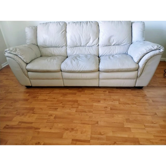 This delightfully comfortable sofa, crafted from fine leather, features a solid wood frame; although it bears no visible...