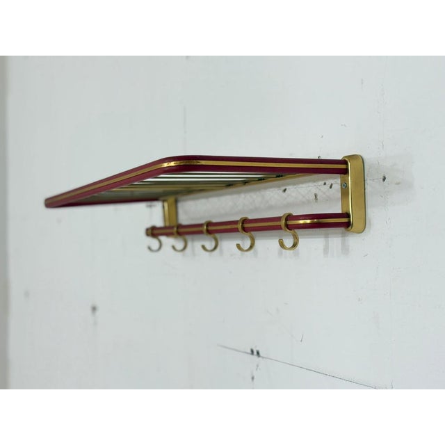 This beautiful wall-mounted coat rack is for sale, captivating with its elegant combination of anodized metal in a...