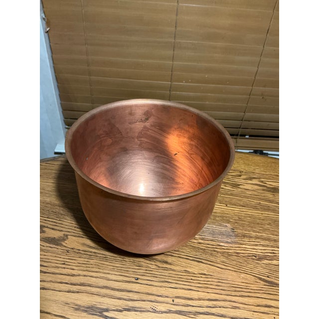 Large vintage copper bowl featuring a classic rounded form with rolled rim and naturally aged patina. Crafted from solid...