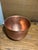 Large vintage copper bowl featuring a classic rounded form with rolled rim and naturally aged patina. Crafted from solid...