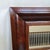 A handsome late-19th-century wall mirror featuring a substantial figured/flamed mahogany veneer frame with deep ogee...