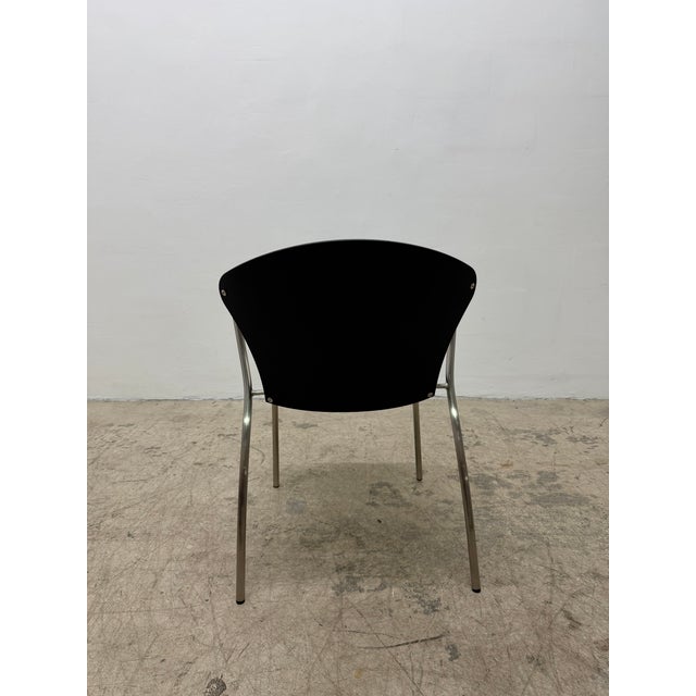 This Bessi E5400 black stackable chair with satin chrome frame was originally designed by Erla Sólveig Óskarsdóttir in...
