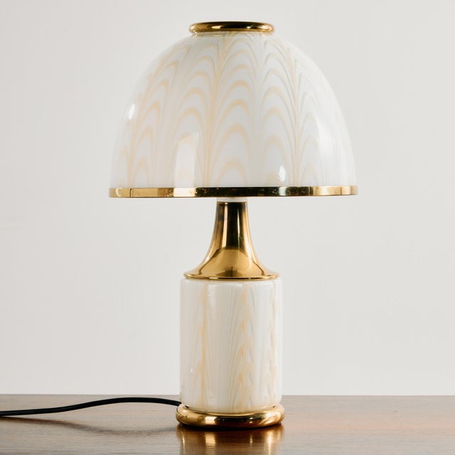 Mazzega table lamp from the 1970s, designed by F. Fabbian. The Murano glass shade and body is decorated with white and...