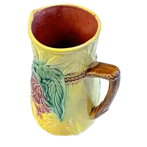 Antique Majolica floral and corn motif pitcher with spout and handle. Rope detail accent. No maker's marks.