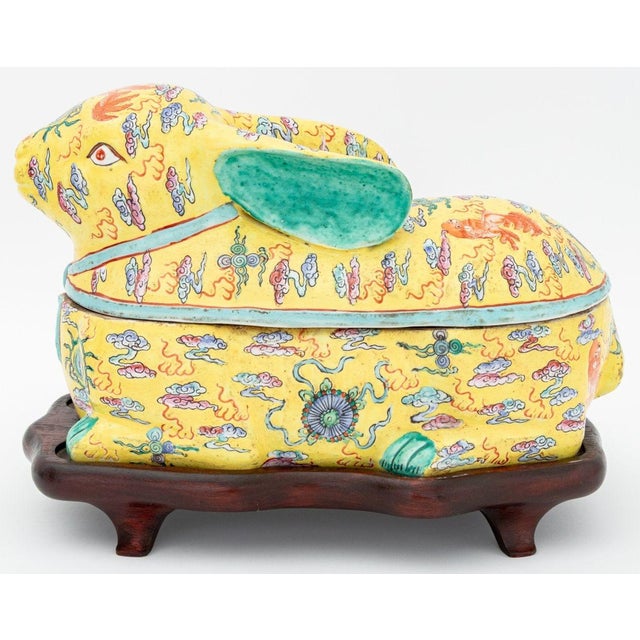 Chinese Rabbit Form Famille Jaune Porcelain Covered Tureen, hand-painted with foo lions amongst clouds, on a fitted carved...