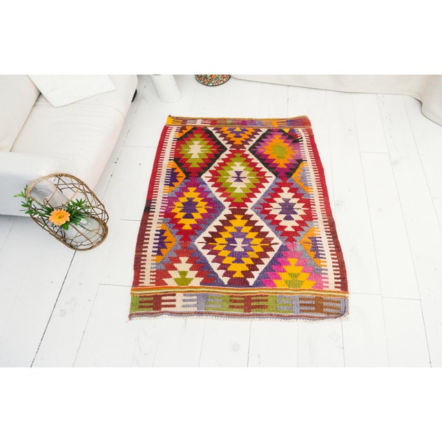 This is a vintage Turkish Oushak rug from the Mid 20th Century. The piece was hand-knotted.