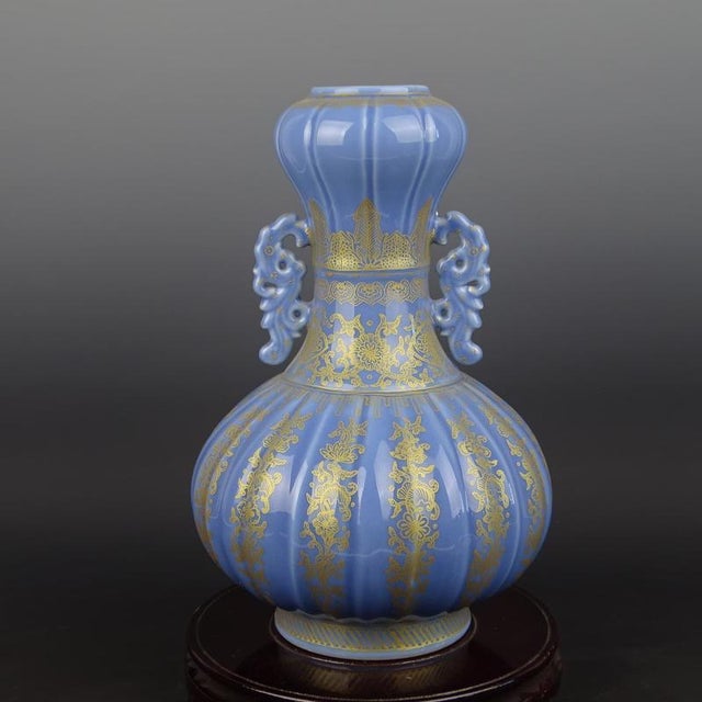 This Chinese Vintage Porcelain Vase from the Qing Dynasty features a Qianlong mark and a stunning blue ground with gold...