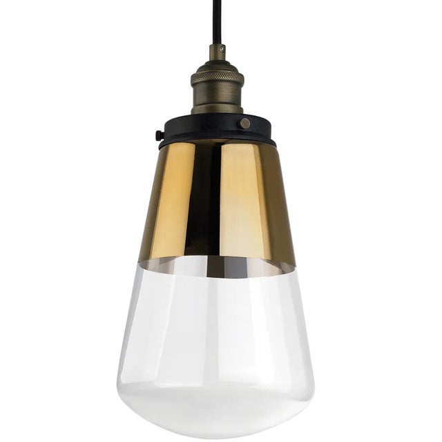 The Waveform one light mini pendant in painted aged brass / dark weathered zinc enhances the beauty of your home with...