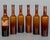 A set of six French amber glass pharmaceutical bottles, one with remnant of paper label. One bottle is slightly different...