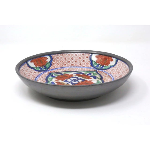 A vintage, hand-painted porcelain bowl, hand-painted with flowers and other designs. Pewter outer lining. Japanese...