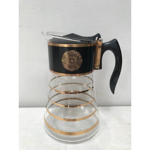 Black and gold carafe/coffeepot by Hollywood Regency designer David Douglas. Heat resistant and as such suitable as...