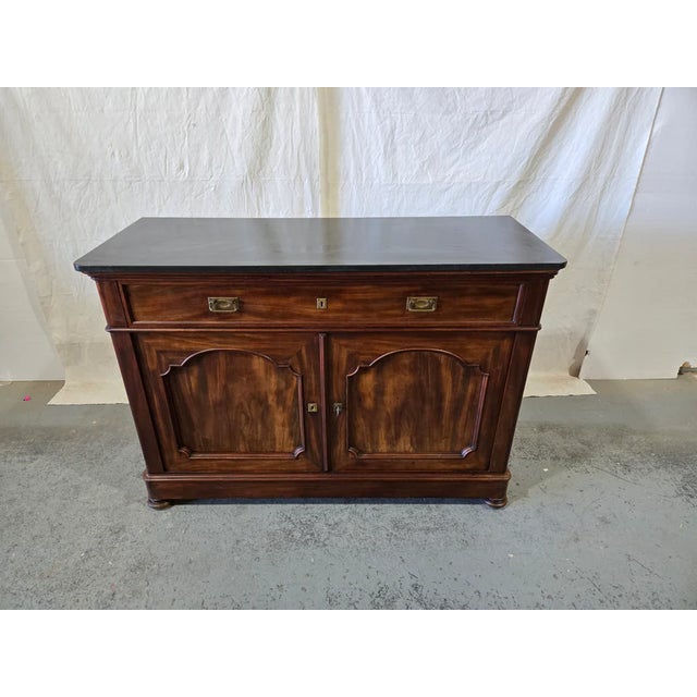 This handsome late 19th-century French Louis Philippe-style buffet is crafted from richly patinated mahogany, showcasing a...