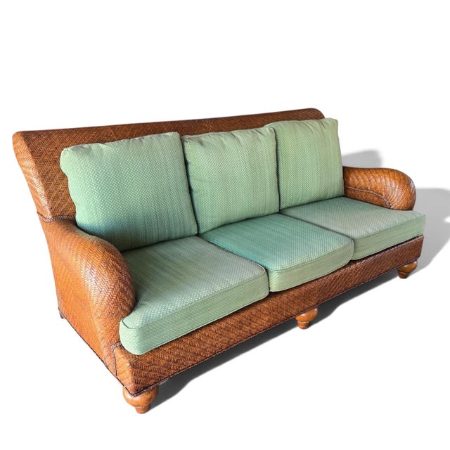 A beautiful woven rattan sofa from Henry Link. Classic transitional coastal style, this piece is beautifully woven with a...