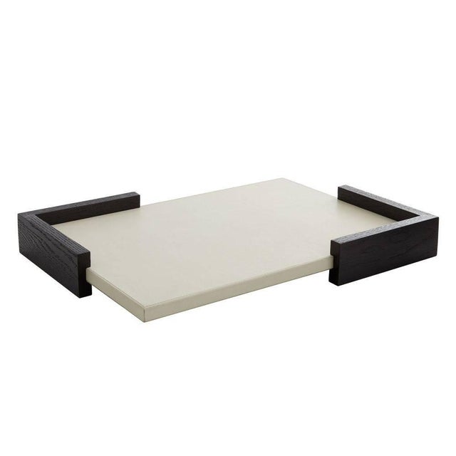 This tray, made from a pairing of oak and leather, is an eye-catching piece on its own. The unique, modern design recalls...