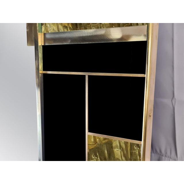 The Magnificent black Murano glass and brass wall mirror with square geometric trim is an extraordinary piece of modern...
