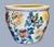 A charming hand‑painted Chinese ceramic bowl featuring a colorful floral and bamboo motif with birds and a red floral...