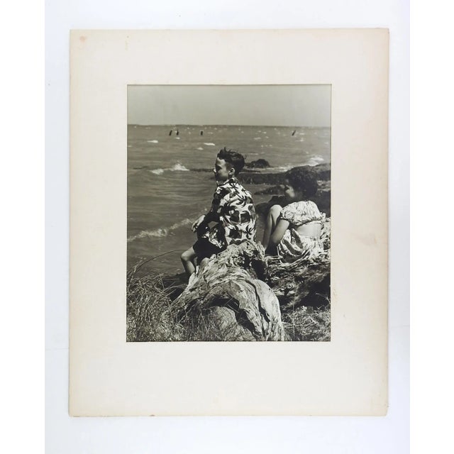 Circa 1950's black and white silver gelatin photograph of children at the beach. Unsigned. Unframed, displayed in original...