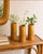 A charming set of three vintage Chinese bamboo bud vases, each hand-carved with detailed landscape scenes featuring...