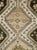 This mid-20th-century Persian Malayer rug presents a bold geometric composition centered on three large stepped medallions...