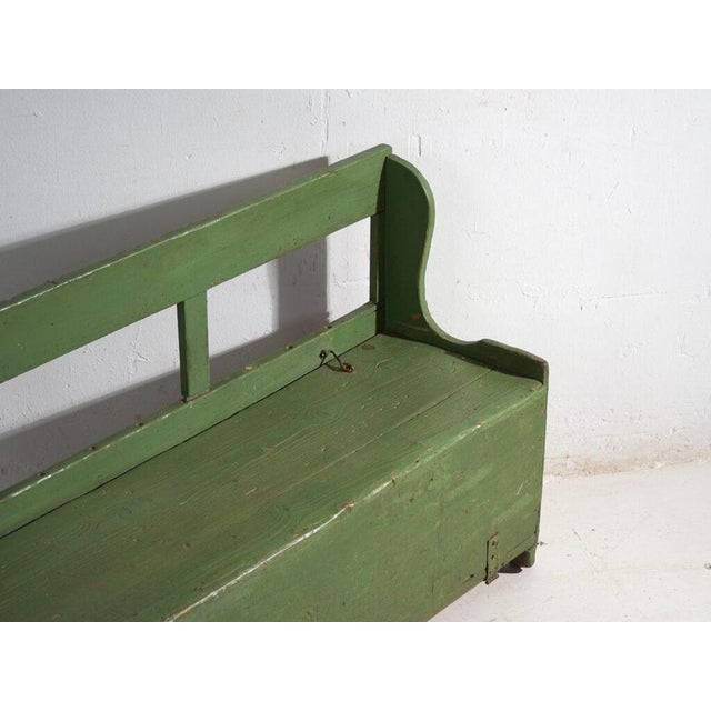 This antique painted storage bench in solid wood pine is a bench with a chest, a lift-up seat and a low back, with shaped...