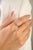 This elegant cluster ring showcases one vibrant oval-cut yellow sapphire totaling 0.73 carats, set in 14k white gold. The...