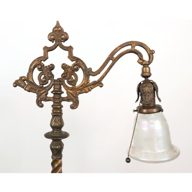 Victorian style bridge arm floor lamp made of cast iron and brass with a bell shaped iridescent stenciled glass shade....