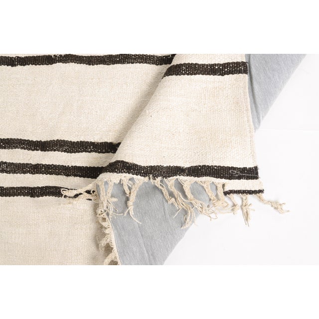 This is a vintage Turkish Oushak rug from the Mid 20th Century. The piece was hand-knotted.