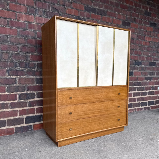 Harvey Probber Mid-Century Modern tall chest crafted in mahogany with distinctive leather and brass-accented sliding...