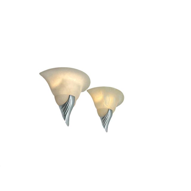 Elegant Art Deco-style alabaster wall lamps with tulip-shaped shades and organically shaped metal brackets. The alabaster...
