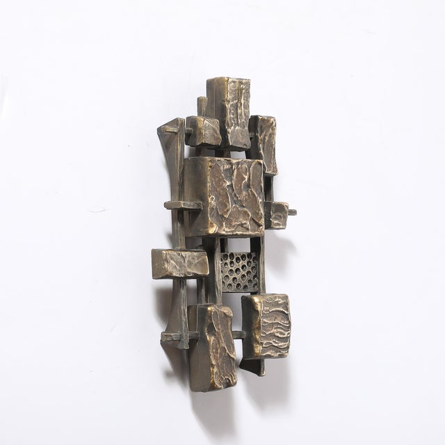 This pair of Mid-Century Brutalist wall sculptures, crafted by Syroco in America circa 1980, is a striking example of...