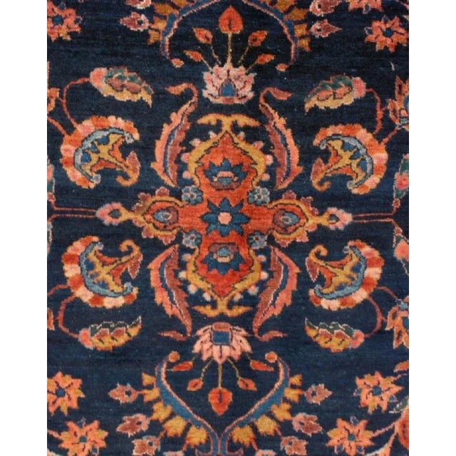A wonderful early 20th Century Persian Lilihan rug with a dark indigo background, covered by a lacy, multicolored...