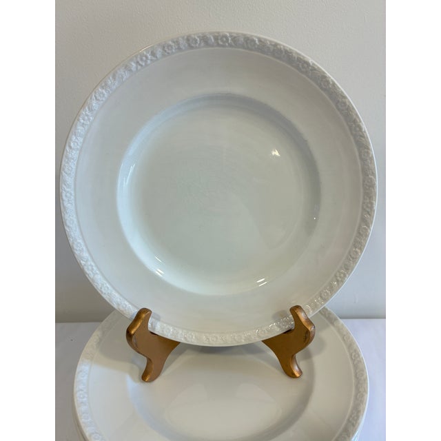A set of 12 vintage Hedge Rose dinner plates by Wedgwood, England. Finished in classic white, each plate features a...