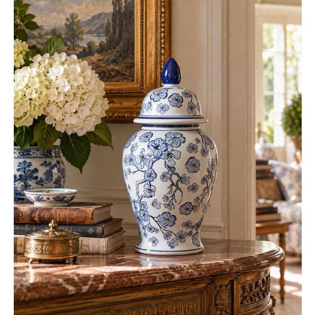 A classic blue and white ginger jar, decorated throughout with delicate flowering cherry blossom branch motifs. The...