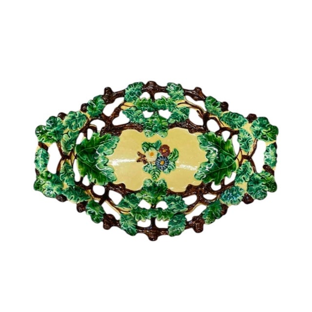 This vintage Italian majolica centerpiece tray features an intricate reticulated ceramic weave design adorned with vibrant...