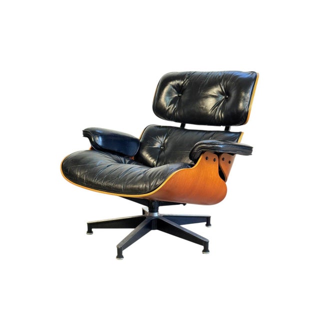Beautiful and authentic Herman Miller Eames lounge chair in black leather with a teak veneer shell. This classic chair...