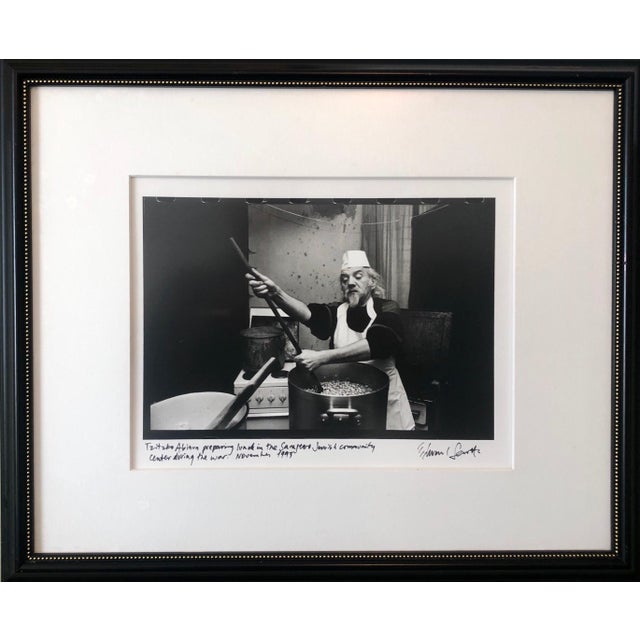 Edward Serotta Tzitzko Abinun (Man cooking) . Judaica. silver gelatin print, matted, captioned by hand and hand signed and...