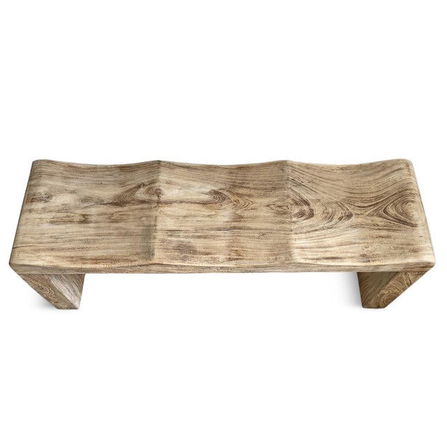 Solid teak bench with a soft wave silhouette. This sculptural bench brings organic movement and natural warmth to both...
